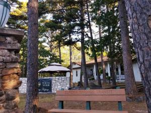 a wooden bench sitting in front of a house at Tuscan Manor in Eureka Springs