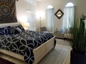 a bedroom with a bed with a black and white comforter at Tuscan Manor in Eureka Springs
