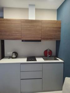 a small kitchen with a sink and a stove at Crystal Resort in Bakuriani