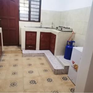 a kitchen with a sink and a counter top at Al Maaroof Appartment in Mombasa