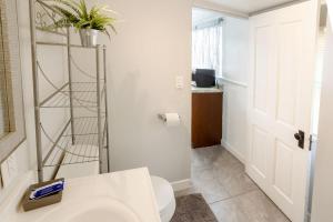 a bathroom with a sink and a toilet with a plant on the wall at Big Studio with Ocean View max 6 sleepers in San Diego