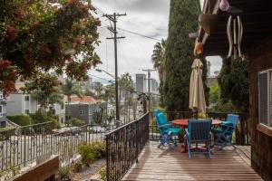 a deck with a table and chairs and an umbrella at Big Studio with Ocean View max 6 sleepers in San Diego