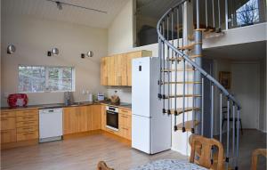 een keuken met een witte koelkast en een trap bij Stunning Home In Ronneby With House Sea View in Ronneby