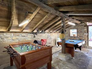 a room with a table with a chessboard and a pool table at Casa Rural Iratxeko-Berea in Bera