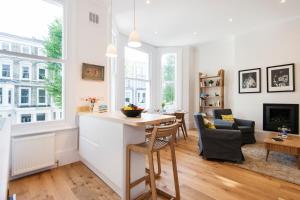 ロンドンにあるThe Stunning Philbeach Garden Apartmentのキッチン、リビングルーム(テーブル、椅子付)