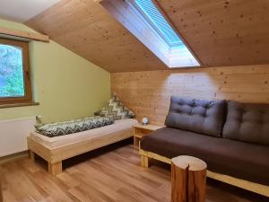 a living room with a couch and a window at Appartement Gsaller in Hopfgarten in Defereggen