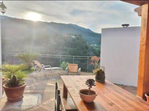 a patio with a table and chairs on a balcony at Holiday Apartment Villa Camilla in Cefalù