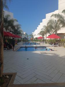 portosaid resort منتجع بورتوسعيد شاليه ارضي مع جاردن في بورسعيد: مجموعة أشخاص في مسبح في منتجع