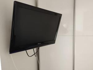 a flat screen tv hanging on a wall at studio du soleil rez de jardin avec parking gratuit in Vence