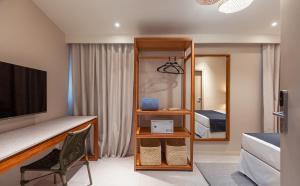 a bedroom with a bed and a mirror at MAIHAI Porto in Porto De Galinhas