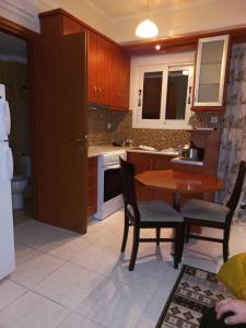a kitchen with a table and chairs and a sink at Ιάνθη studio in Karditsa