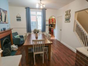 a kitchen and dining room with a table and chairs at Smoked Kipper Cottage in Whitby +13 photos