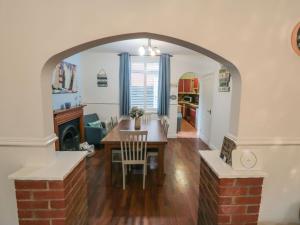 a kitchen and dining room with an archway in a home at Smoked Kipper Cottage in Whitby