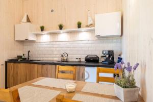 a kitchen with a table and a counter top at Family holiday homes, Jaroslawiec in Jarosławiec +28 photos