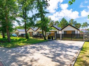a driveway in front of a house with a fence at Family holiday homes, Jaroslawiec in Jarosławiec