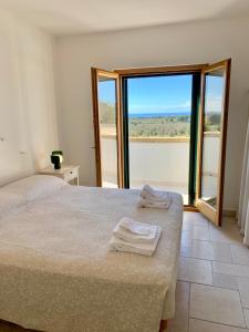 a bedroom with a bed with two towels on it at Villa Sant'Anna - Pescoluse in Salve