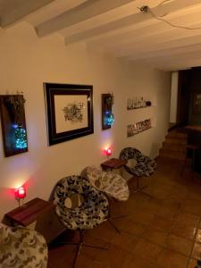 a room with chairs and tables and some lights at Las Puertas Del Indiano in Relleu