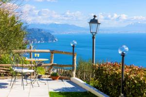 a patio with a table and a view of the ocean at Il Giardino di Rosa in Amalfi