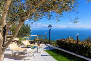a patio with a view of the ocean at Il Giardino di Rosa in Amalfi