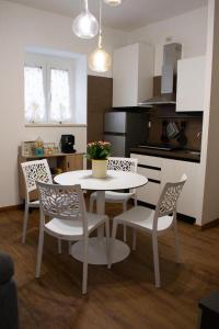 a kitchen with a white table and chairs in a room at M&G holiday house in Matera