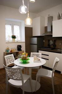 a kitchen with a white table and chairs and a table and chairsktop at M&G holiday house in Matera