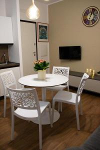 a white table and chairs in a living room at M&G holiday house in Matera +61 photos