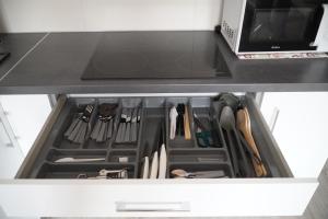 eine Schublade in einer Küche mit Messern und Küchenutensilien in der Unterkunft Jedenastka in Płock