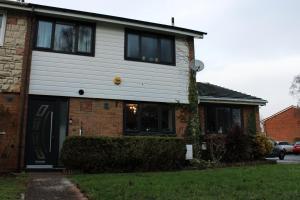a house with black windows and a brick at Stylish 4-Bedroom House near NEC/BHX in Solihull