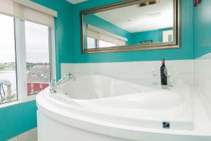a bathroom with a white sink and a mirror at Brigantine Inn in Lunenburg +33 photos
