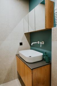 a bathroom with a white sink on a counter at Adastro Apartment 17 in Thessaloniki