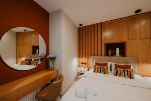 a bedroom with a large mirror and a bed at Adastro Apartment 17 in Thessaloniki