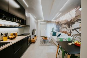 a kitchen and living room with a couch and a table at Adastro Apartment 17 in Thessaloniki