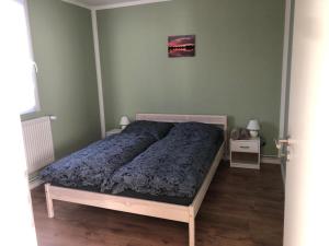 1 dormitorio con 1 cama con edredón azul en Naturheilcamp Götzer Berge, en Groß Kreutz