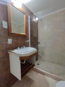 a bathroom with a sink and a shower at Catalina Hotel in Colón