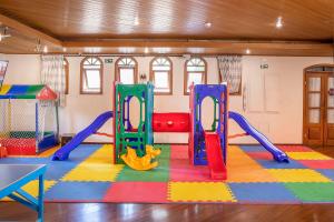 a play room with a slide and a playground at Hotel Estoril in Campos do Jordão