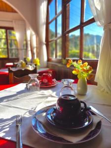 a table with a plate of food on a table at Pousada Cantinho da Paz in Itatiaia