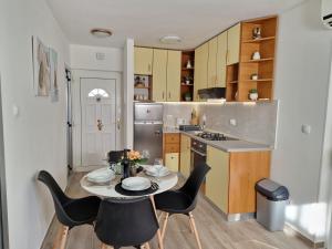 a kitchen with a table and chairs in a kitchen at Apartments Duje in Split