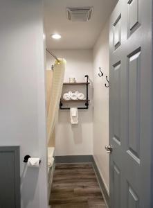 a bathroom with a toilet and a door at Canyon Motel in Wellsboro