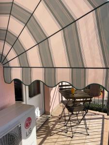 a table and a chair on a balcony at Le Bassotte b&b in Perugia