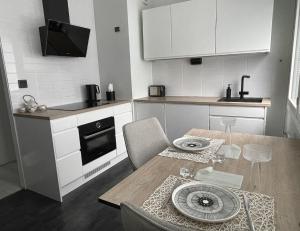 a kitchen with a wooden table and a dining room at Modern room in the city centre in Tampere