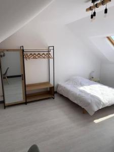 a white room with a bed and a mirror at appartement F5 - 4 chambres lit double- 2 SDB in Bourges