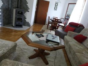 ein Wohnzimmer mit einem Couchtisch und einem Laptop darauf in der Unterkunft Bjelasica Home in Kolašin