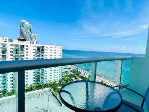 a balcony with a view of the ocean and buildings at Hollywood on Beach Apartment in Hollywood