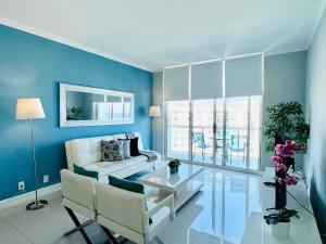 a living room with a white couch and a table at Hollywood on Beach Apartment in Hollywood
