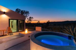a backyard with a swimming pool and a fire pit at Sarab Hotel in Ensenada