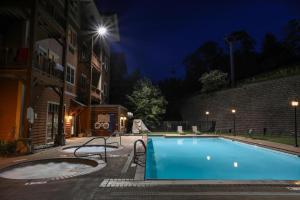 a swimming pool in a courtyard at night at Slopeside Ski-In/Ski-Out ; HotTub ; 2 Room 2 Bath in Hunter