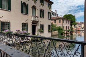 a view of a river from a balcony of a building at Buranelli Charme Rooms in Treviso