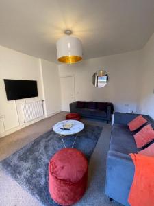 a living room with a couch and a table at 2 Bedroom House with Garden Next to River Tees in Stockton-on-Tees