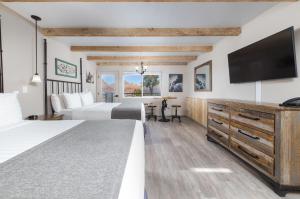 a hotel room with two beds and a flat screen tv at Sky Ranch Lodge in Sedona