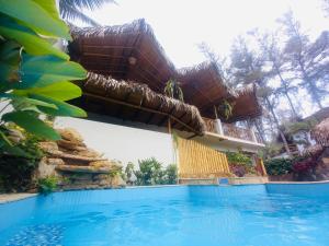 una casa con piscina frente a ella en Tres Palmas en Montañita